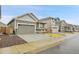 Street view of single-Gathering homes with well-manicured lawns, attached garages, and a sidewalk at 239 Chipeta Way, Lochbuie, CO 80603