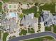 Aerial view showcases a pool, sport court, lush landscaping, and elegant homes at 10826 Evergold Way, Highlands Ranch, CO 80126