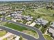 Aerial view of a community with manicured lawns, mature trees, and winding roads at 10826 Evergold Way, Highlands Ranch, CO 80126