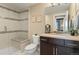 Modern bathroom featuring a glass enclosed shower, neutral tile, and a dark vanity at 10826 Evergold Way, Highlands Ranch, CO 80126