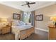 Bedroom with hardwood bed frame, warm lighting, and large window at 10826 Evergold Way, Highlands Ranch, CO 80126