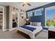 Bedroom with a blue accent wall and view into a bathroom at 10826 Evergold Way, Highlands Ranch, CO 80126