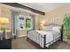 Cozy bedroom featuring a metal frame bed, neutral walls, and a view to the outside at 10826 Evergold Way, Highlands Ranch, CO 80126