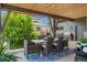 Outdoor covered deck with dining table, offering scenic backyard and neighborhood views at 10826 Evergold Way, Highlands Ranch, CO 80126