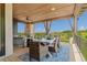 Charming covered deck featuring an outdoor dining area, perfect for enjoying meals with a view at 10826 Evergold Way, Highlands Ranch, CO 80126