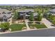 Well-maintained front yard with landscaped garden beds and a paved driveway at 10826 Evergold Way, Highlands Ranch, CO 80126