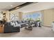 Open living room with a sectional sofa, large windows, and neutral tones creating a relaxing atmosphere at 10826 Evergold Way, Highlands Ranch, CO 80126