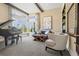 Bright living room featuring large windows, a piano, and comfortable seating arrangement at 10826 Evergold Way, Highlands Ranch, CO 80126