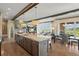 Open-concept living space with a kitchen island, dining area, and living room filled with natural light at 10826 Evergold Way, Highlands Ranch, CO 80126