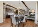 Open concept living space with dining area and kitchen visible from a comfortable living room at 10826 Evergold Way, Highlands Ranch, CO 80126