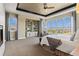 Inviting bedroom featuring a cozy sitting area, built-in shelving, and expansive windows for scenic views at 10826 Evergold Way, Highlands Ranch, CO 80126