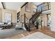 An open staircase with metal railings complements the home's modern design and open-concept layout at 10826 Evergold Way, Highlands Ranch, CO 80126