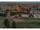 A backyard with a basketball court, tennis court, pool and fire pit is featured in an aerial view at 10826 Evergold Way, Highlands Ranch, CO 80126