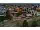 An aerial view shows a home and backyard with a basketball court, tennis court, pool and fire pit at 10826 Evergold Way, Highlands Ranch, CO 80126