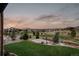 A spacious backyard offers a basketball court with views of neighborhood at 10826 Evergold Way, Highlands Ranch, CO 80126