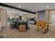 Finished basement featuring a TV area, foosball table, fireplace, and bar seating area at 10826 Evergold Way, Highlands Ranch, CO 80126