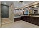 A modern bathroom with a glass shower, double sink vanity, and a soaking tub with a sunset view at 10826 Evergold Way, Highlands Ranch, CO 80126