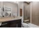 A bathroom featuring a glass shower and modern vanity with a light countertop at 10826 Evergold Way, Highlands Ranch, CO 80126