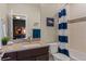 Well-lit bathroom featuring a vanity with a sink, toilet, and shower with a blue and white curtain at 10826 Evergold Way, Highlands Ranch, CO 80126
