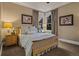 Cozy bedroom with light blue bedding, corner windows, and carpeted floor at 10826 Evergold Way, Highlands Ranch, CO 80126