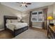 Bedroom featuring a bed with a wooden frame, neutral colored walls, and a window with a sunset view at 10826 Evergold Way, Highlands Ranch, CO 80126