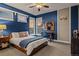 Cozy bedroom with sunset views, a comfortable bed, desk, and a cool sports theme at 10826 Evergold Way, Highlands Ranch, CO 80126