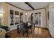 Dining room features modern lighting, hardwood floors, and view to outside at 10826 Evergold Way, Highlands Ranch, CO 80126