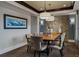 Formal dining room with stylish lighting, stone accent wall, and seating for eight at 10826 Evergold Way, Highlands Ranch, CO 80126