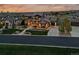 A modern luxury home with stone and dark siding sits on a beautifully landscaped lot at 10826 Evergold Way, Highlands Ranch, CO 80126