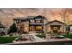 Stunning stone-clad home featuring a professionally landscaped front yard and charming walkway at 10826 Evergold Way, Highlands Ranch, CO 80126