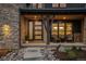 Inviting front porch with stone accents, stylish seating, and a welcoming entrance at 10826 Evergold Way, Highlands Ranch, CO 80126