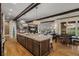 Open kitchen with a long granite island, connecting to living and dining areas for seamless living at 10826 Evergold Way, Highlands Ranch, CO 80126