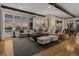 Bright living room boasts hardwood floors, exposed beams, and view to the outside at 10826 Evergold Way, Highlands Ranch, CO 80126