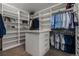 Spacious walk-in closet with ample shelving and storage, providing organized space for clothing and accessories at 10826 Evergold Way, Highlands Ranch, CO 80126