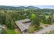 Aerial view showcases this home situated amongst mature trees with circular drive and ample parking at 21859 Grandview Ave, Golden, CO 80401