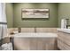 A luxurious soaking tub features modern wood-look tile surround for a spa-like retreat at 21859 Grandview Ave, Golden, CO 80401
