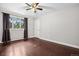 Bright bedroom with hardwood floors, a ceiling fan, and a large window with tree views at 21859 Grandview Ave, Golden, CO 80401
