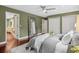 Bedroom featuring hardwood floors, a ceiling fan, and stylish mirror at 21859 Grandview Ave, Golden, CO 80401