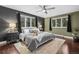 Serene bedroom with hardwood floors, cozy rug and large windows offering wooded view at 21859 Grandview Ave, Golden, CO 80401