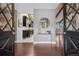Inviting foyer with hardwood floors, decorative mirror, and views into the kitchen and living spaces at 21859 Grandview Ave, Golden, CO 80401