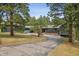 Charming ranch-style home with mature trees, spacious driveway, and inviting entryway at 21859 Grandview Ave, Golden, CO 80401
