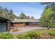 Charming single story home with a stone facade, mature trees, and a long driveway at 21859 Grandview Ave, Golden, CO 80401