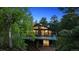 Charming home with a spacious deck and large windows, surrounded by lush greenery and trees at 21859 Grandview Ave, Golden, CO 80401