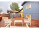 Spacious backyard deck area, with outdoor seating and a well-manicured garden and lawn at 901 Delphi Dr, Lafayette, CO 80026
