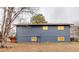 Back exterior view of house with a spacious yard and a deck, as well as visible windows at 901 Delphi Dr, Lafayette, CO 80026