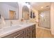 Modern bathroom with double vanity, quartz countertop, framed mirrors, and glass-enclosed shower at 901 Delphi Dr, Lafayette, CO 80026