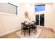 Cozy dining area with table set for four, modern light fixture, and view of the backyard at 901 Delphi Dr, Lafayette, CO 80026