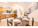 Open dining area with a wooden table set for four, adjacent to a modern kitchen and stairs at 901 Delphi Dr, Lafayette, CO 80026