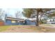 Exterior side view of blue home featuring a well-maintained lawn and attached garage at 901 Delphi Dr, Lafayette, CO 80026