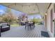 Inviting covered back deck featuring an outdoor dining set and comfortable seating, perfect for entertaining at 13367 W Montana Pl, Lakewood, CO 80228